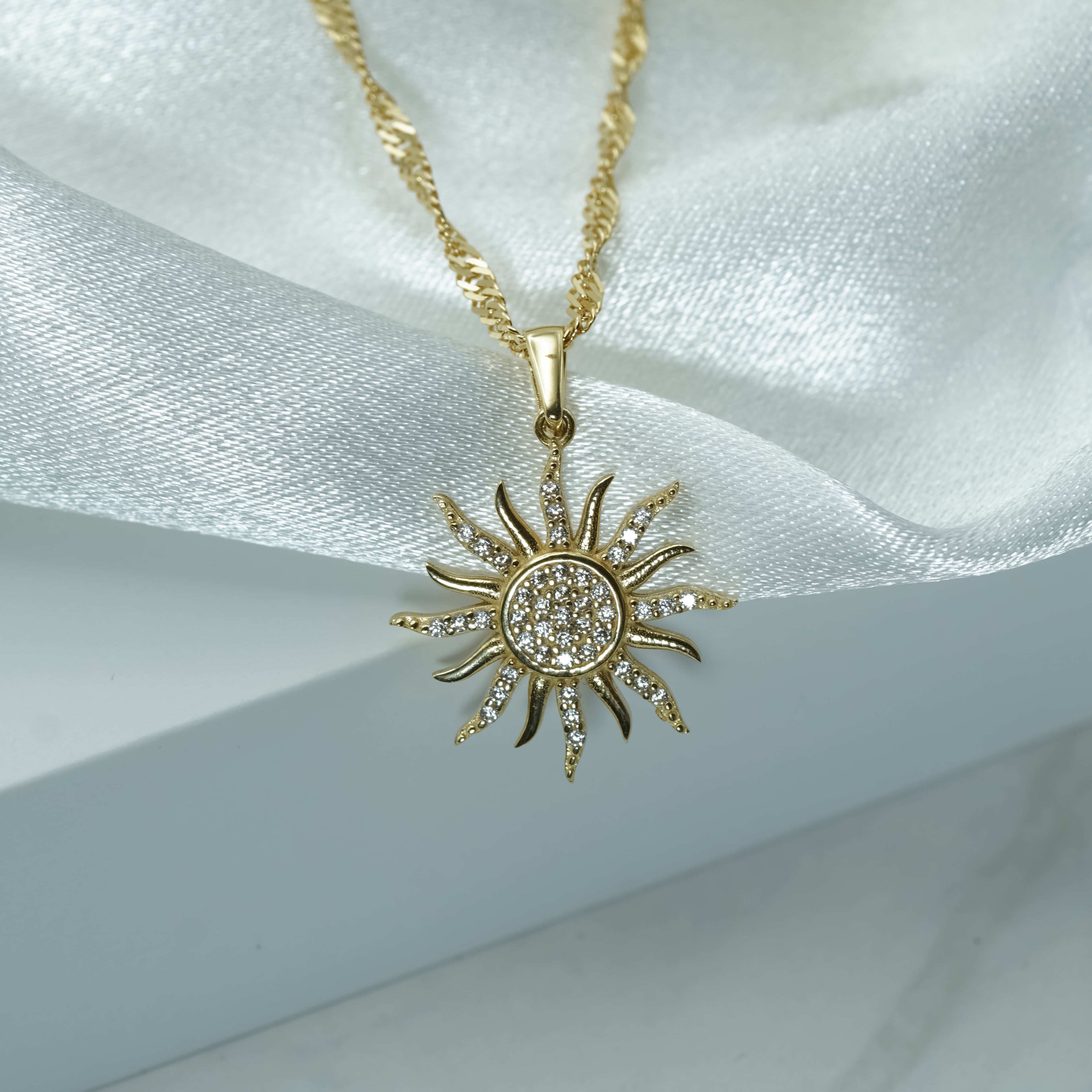 Zirconia Sunburst Charm Necklace in Yellow Gold